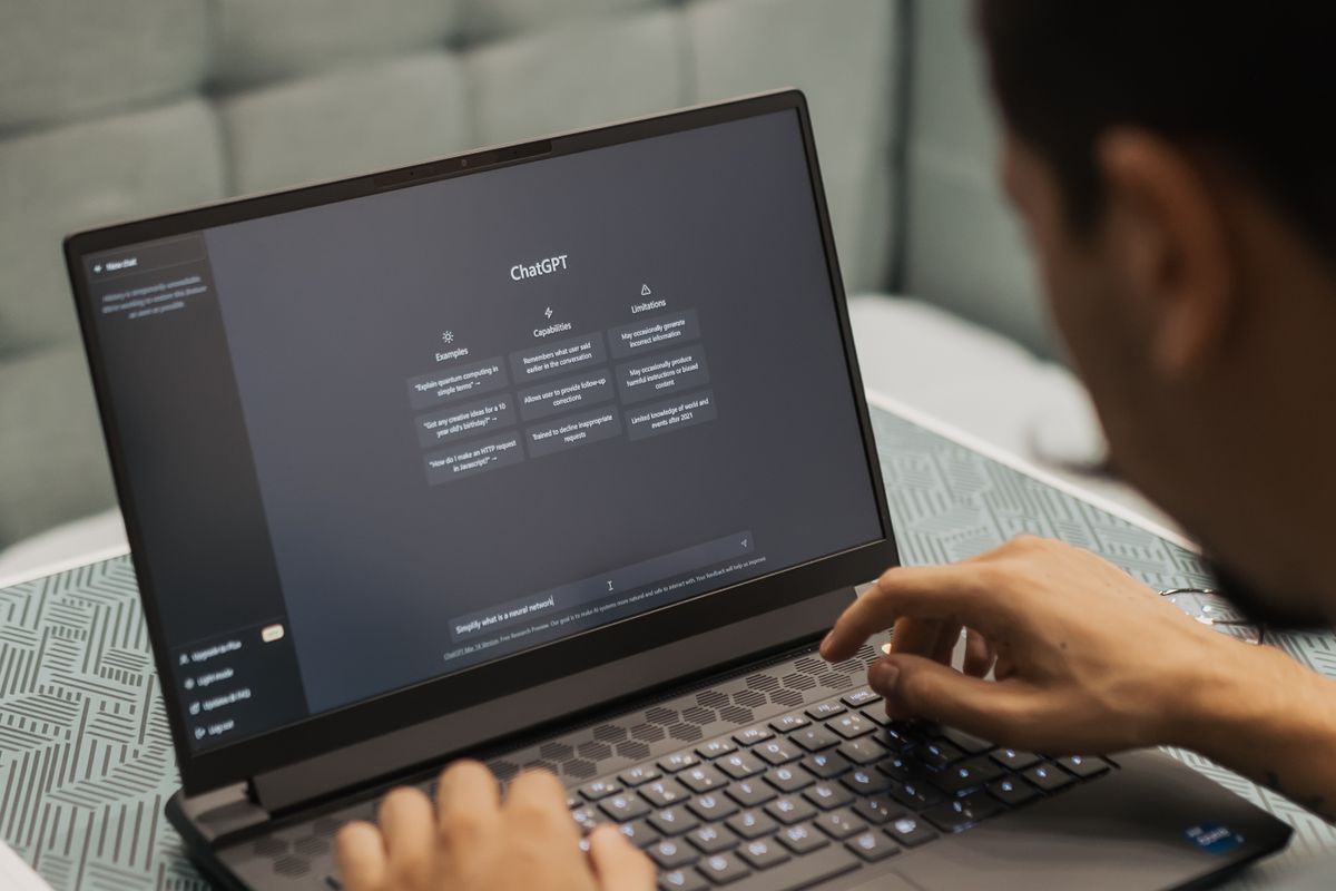 Person using AI dictation software on a laptop in a modern workspace