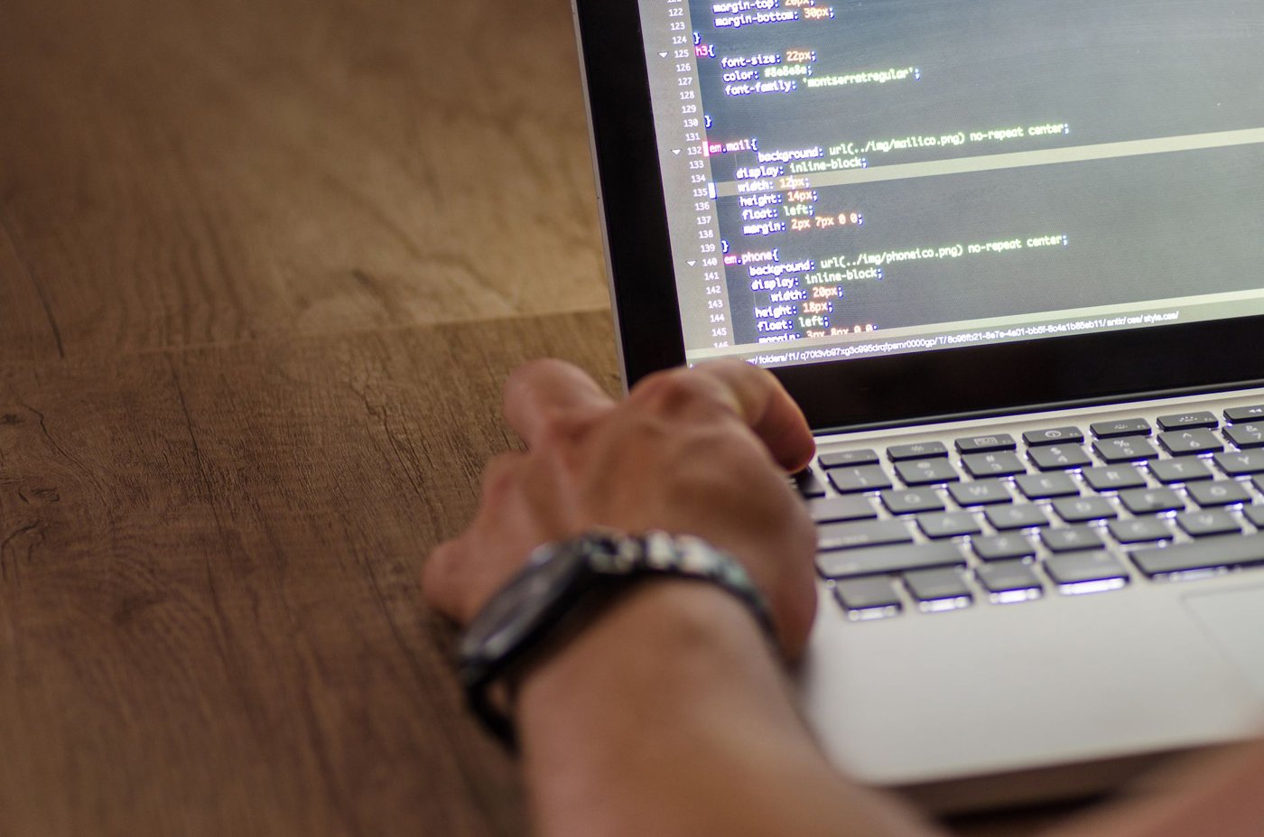 Developer workstation with code on a monitor, representing enterprise software teams