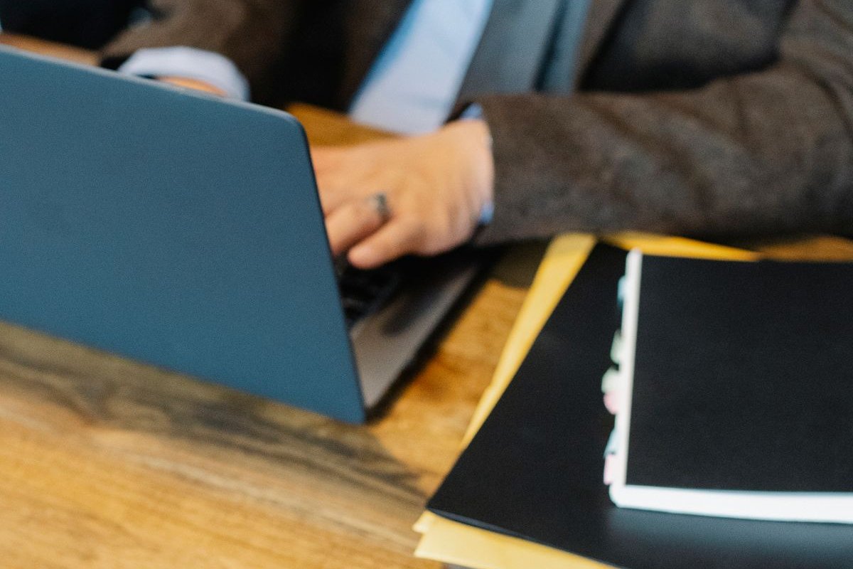 Lawyer working on a laptop beside a gavel and legal case files