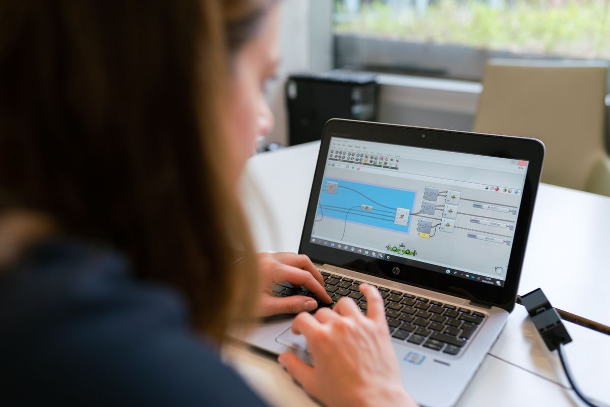 Engineer working on a laptop with software, representing developers integrating AI transcription APIs