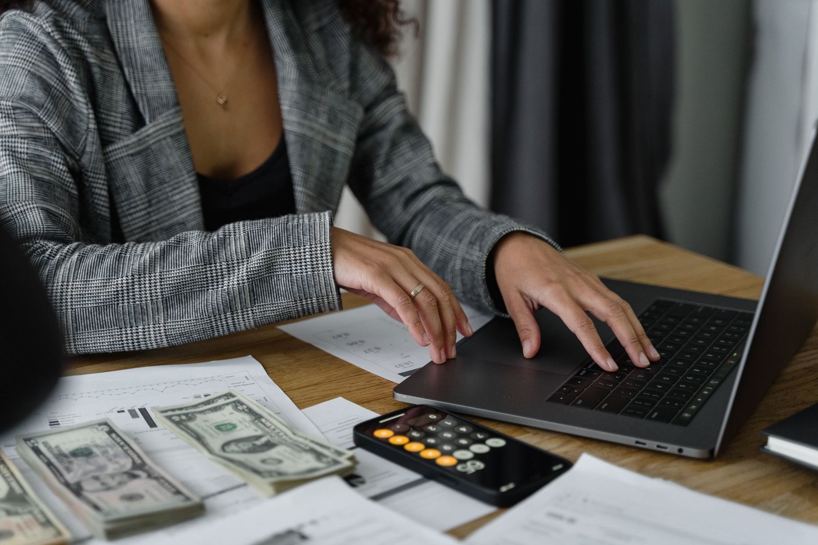 Small business owner reviewing bookkeeping records on a laptop