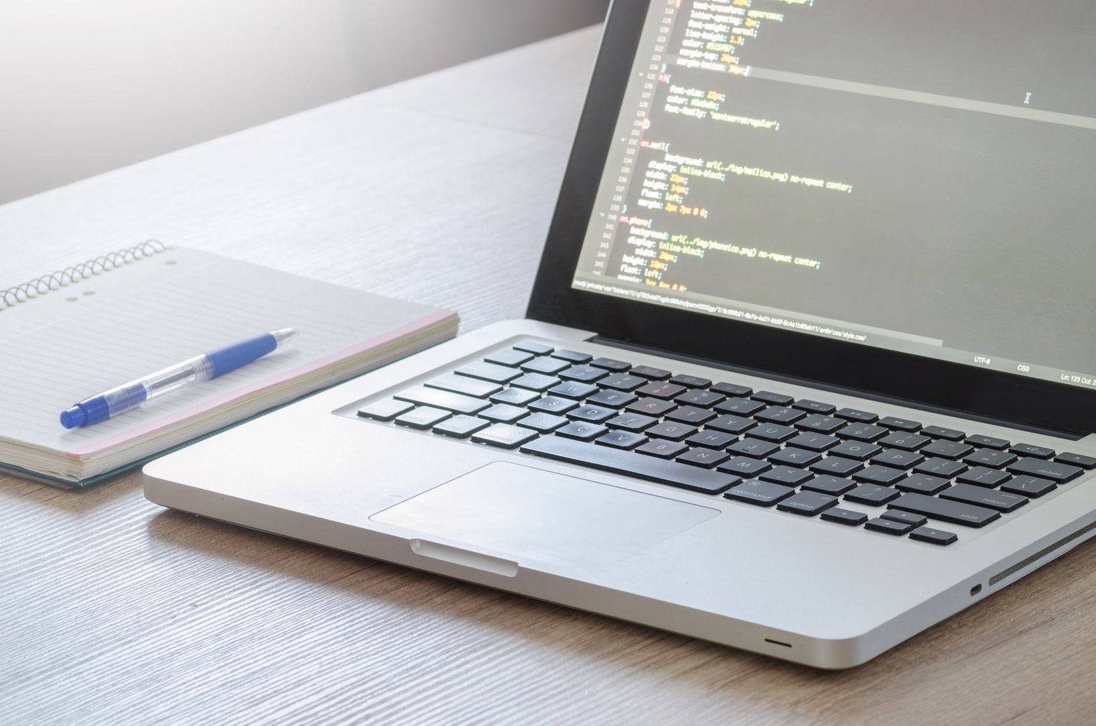 React and Tailwind style code shown on a laptop display