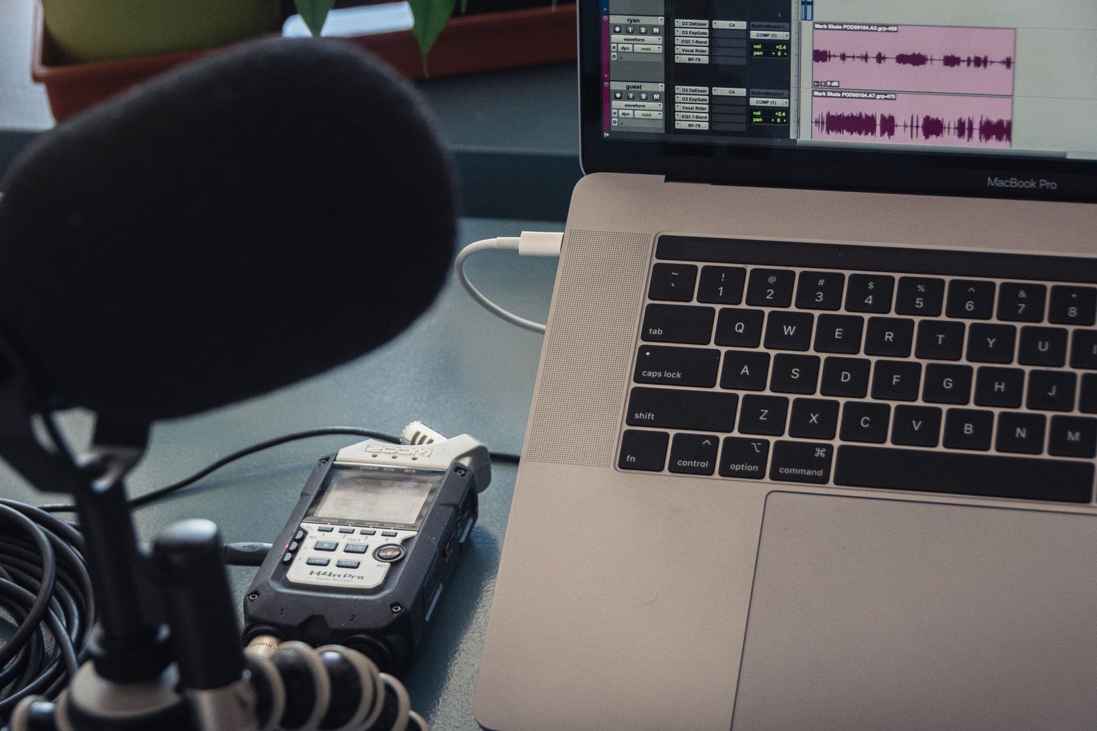 Microphone and laptop transcription setup illustrating Atlas-1 vs Deepgram comparison