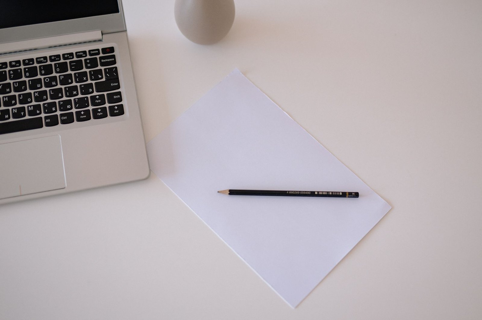 Minimalist workspace with laptop and paper for editing long-form writing