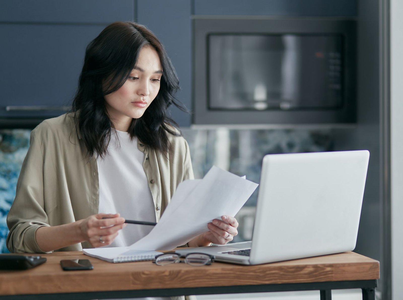 Person analyzing long documents on a laptop with an AI assistant