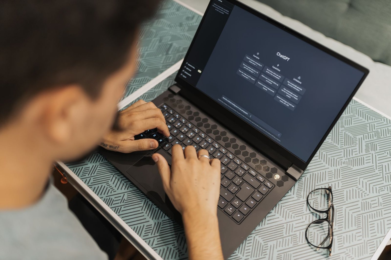 Person working on a laptop with an AI chat assistant open on screen