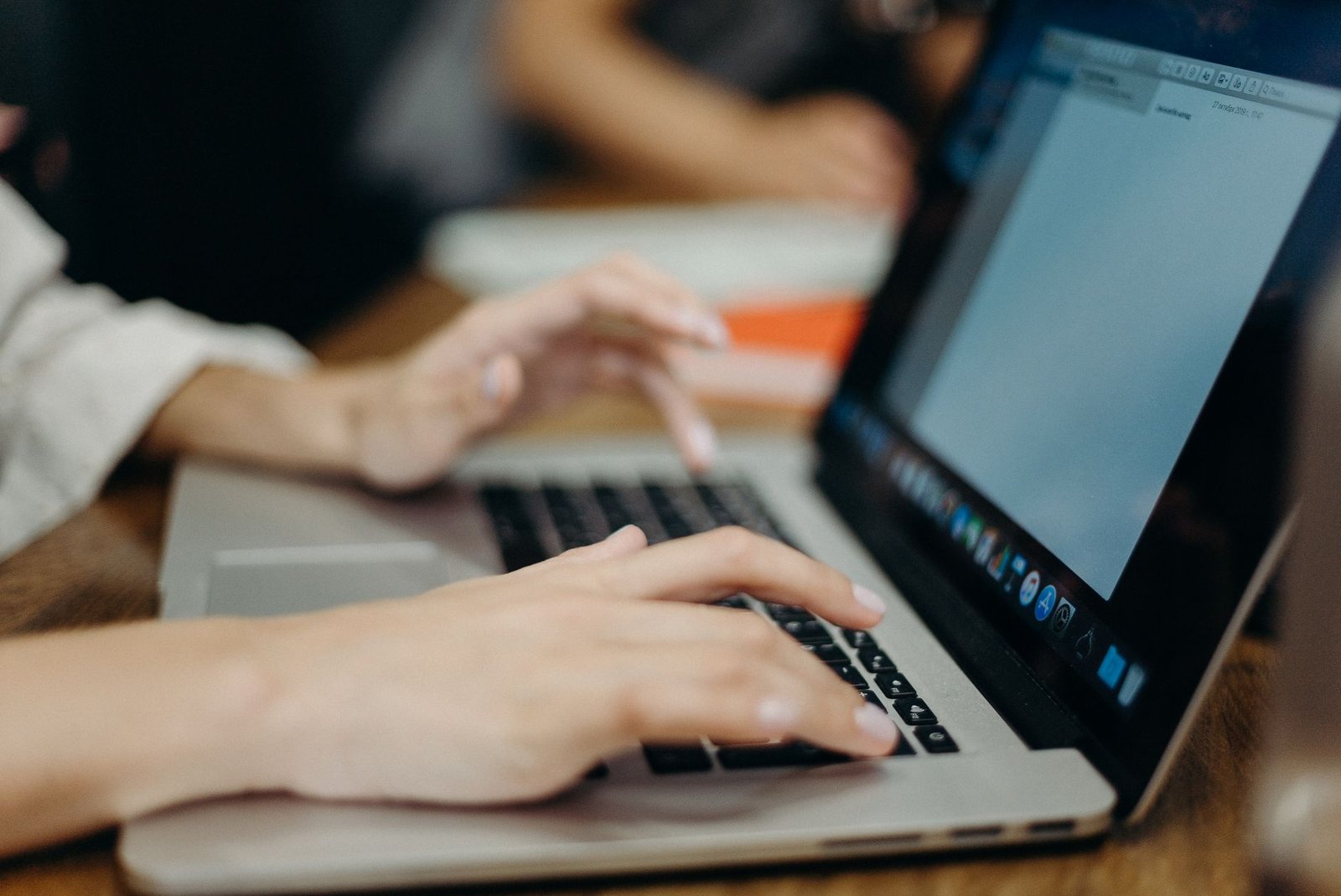 A marketer typing on a laptop, the kind of content workflow Jasper AI is built to speed up