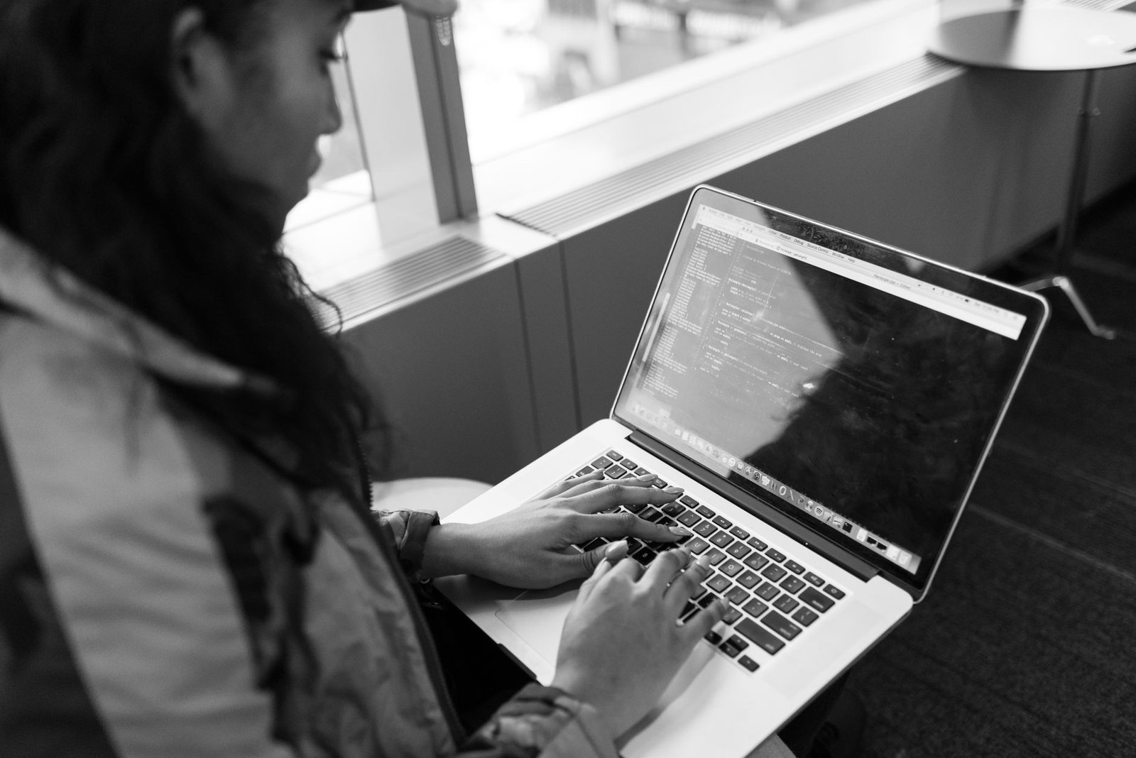 Developer writing React code on a laptop, illustrating a Lovable AI review workflow