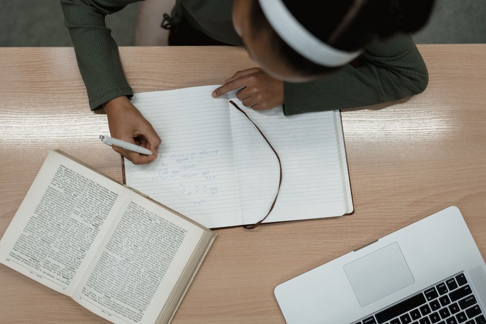 Researcher working through documents with a laptop and notes