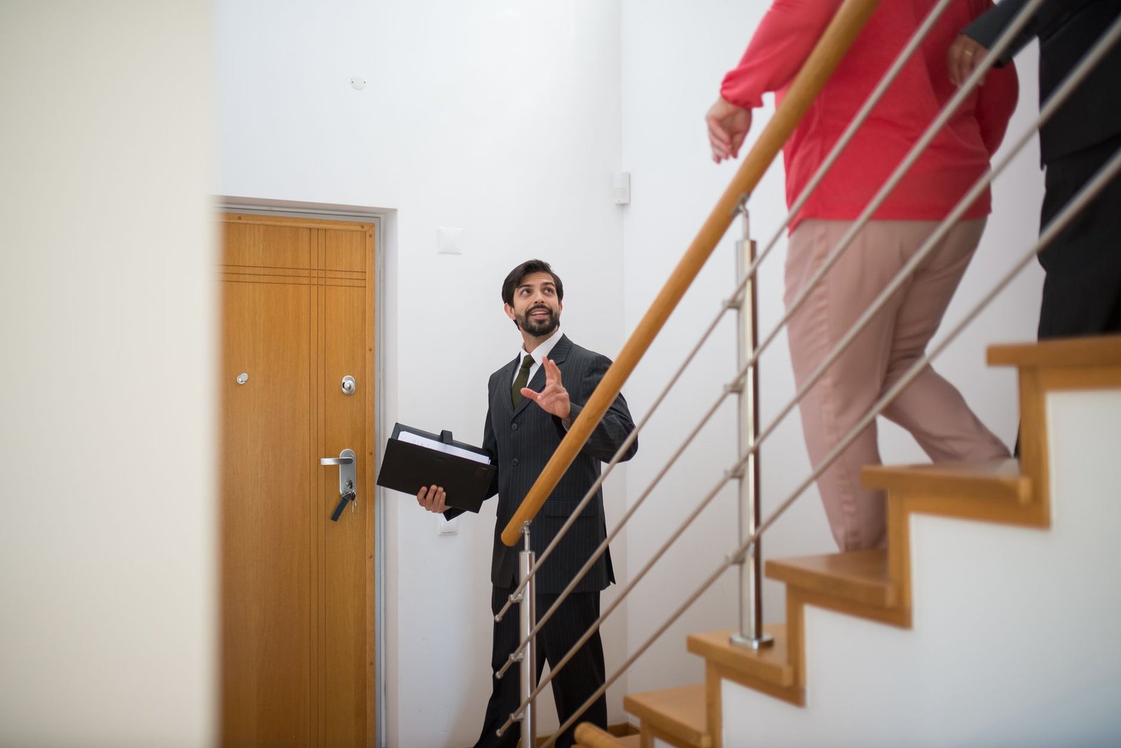 Real estate agent giving a home tour to buyers