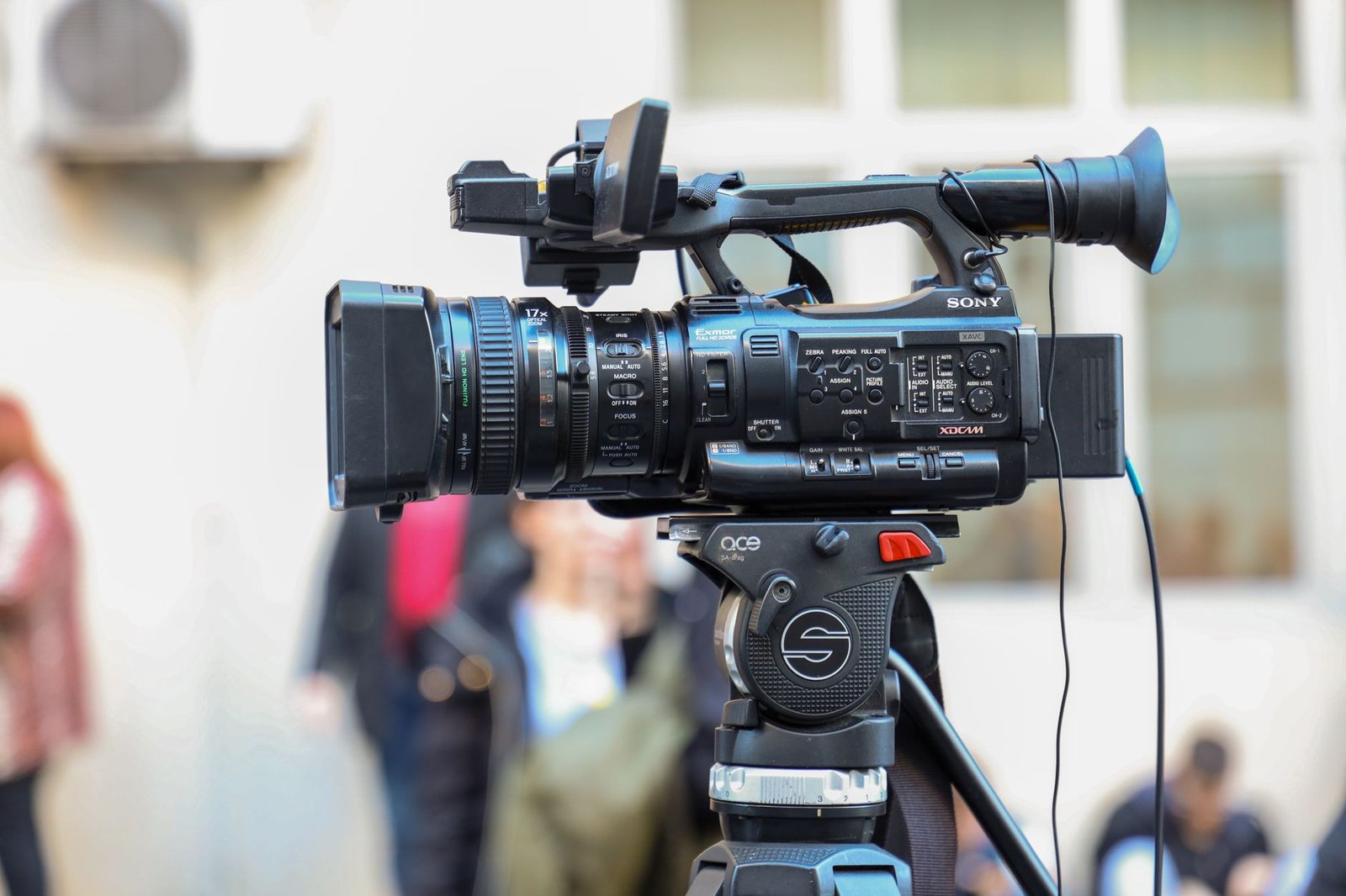 Professional video camera mounted on a tripod for an outdoor shoot