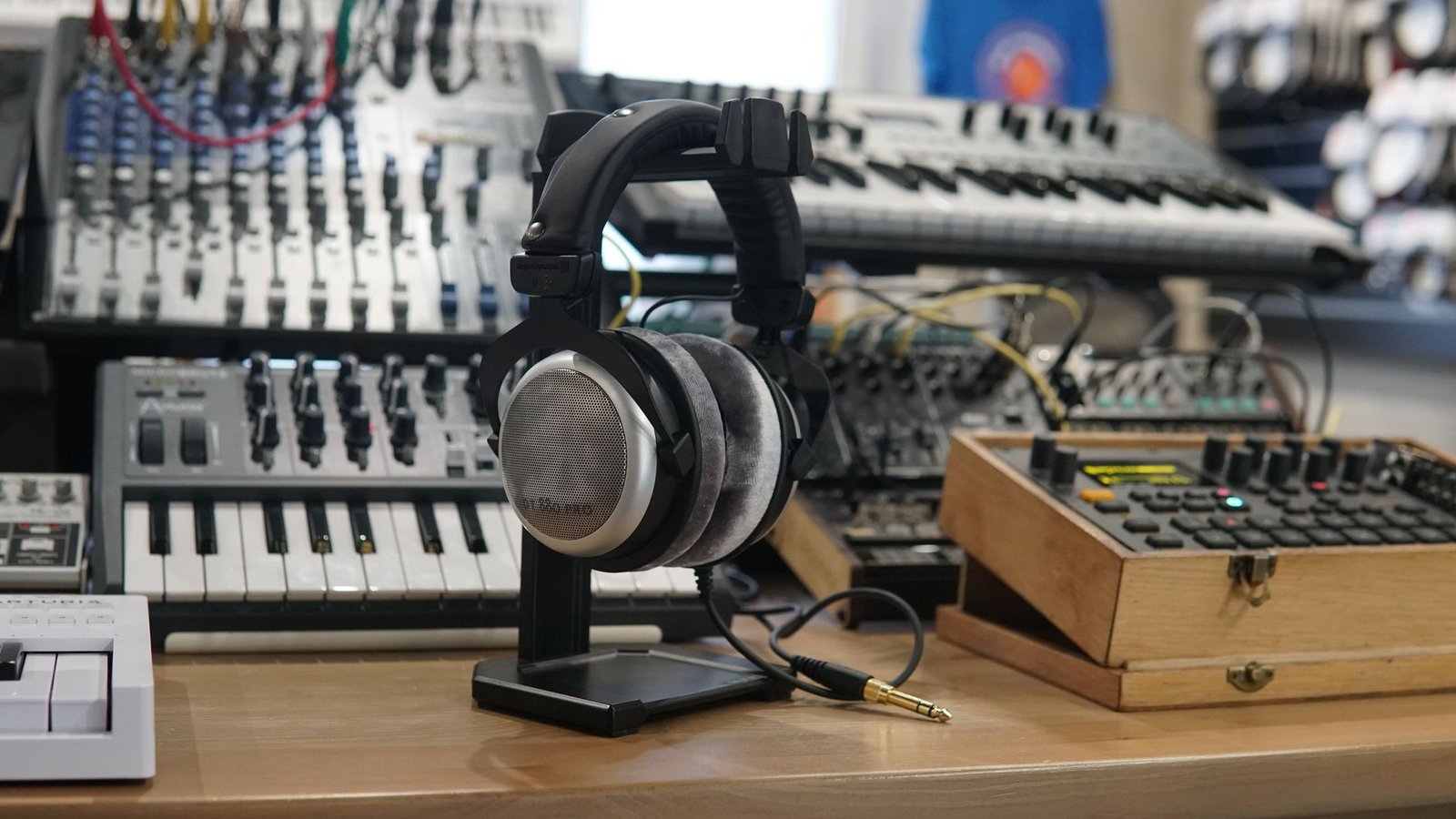 Headphones and synthesizers in a modern music production studio setup