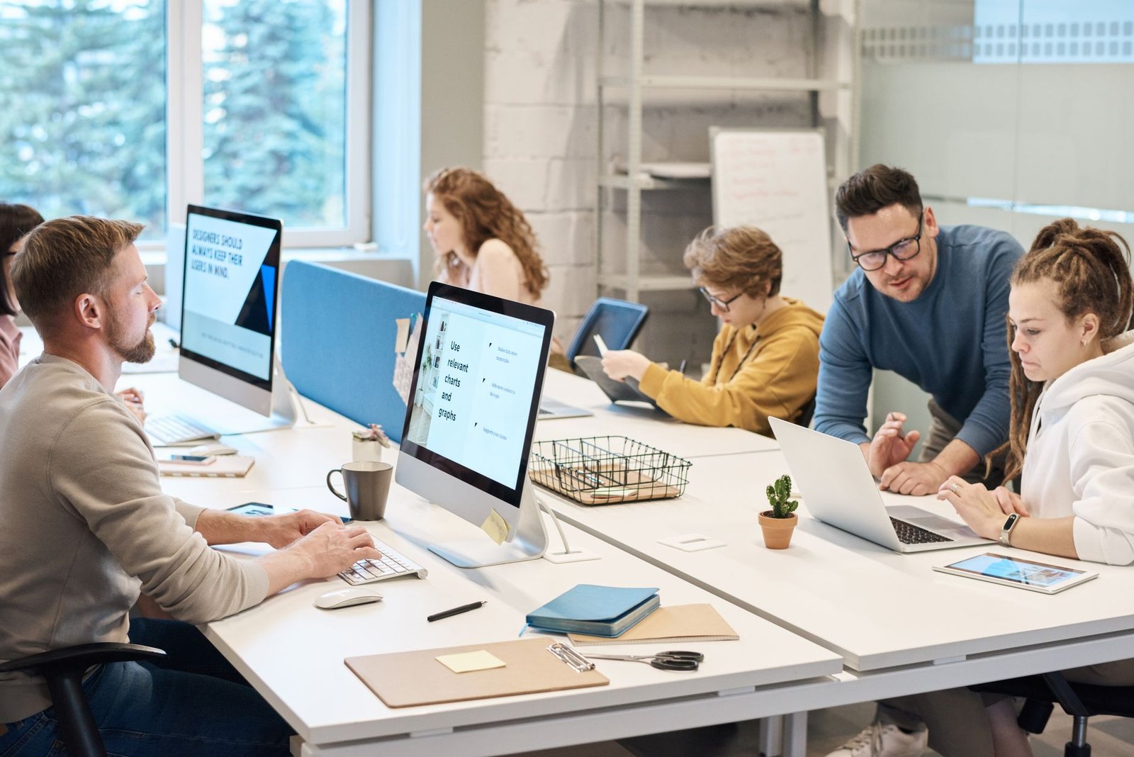Team collaborating in an office using project management software
